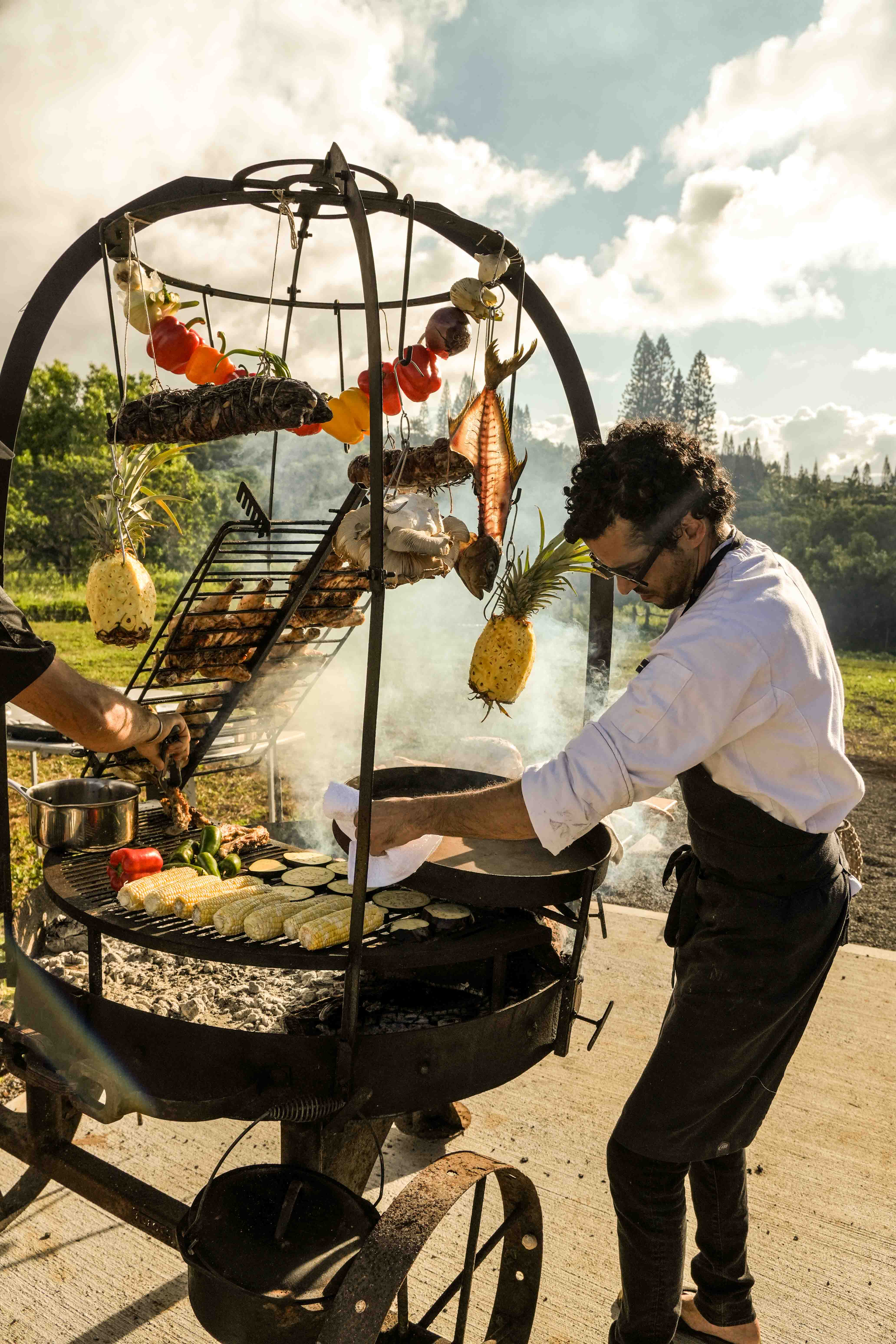 Chef cooking over an open fire on the farm