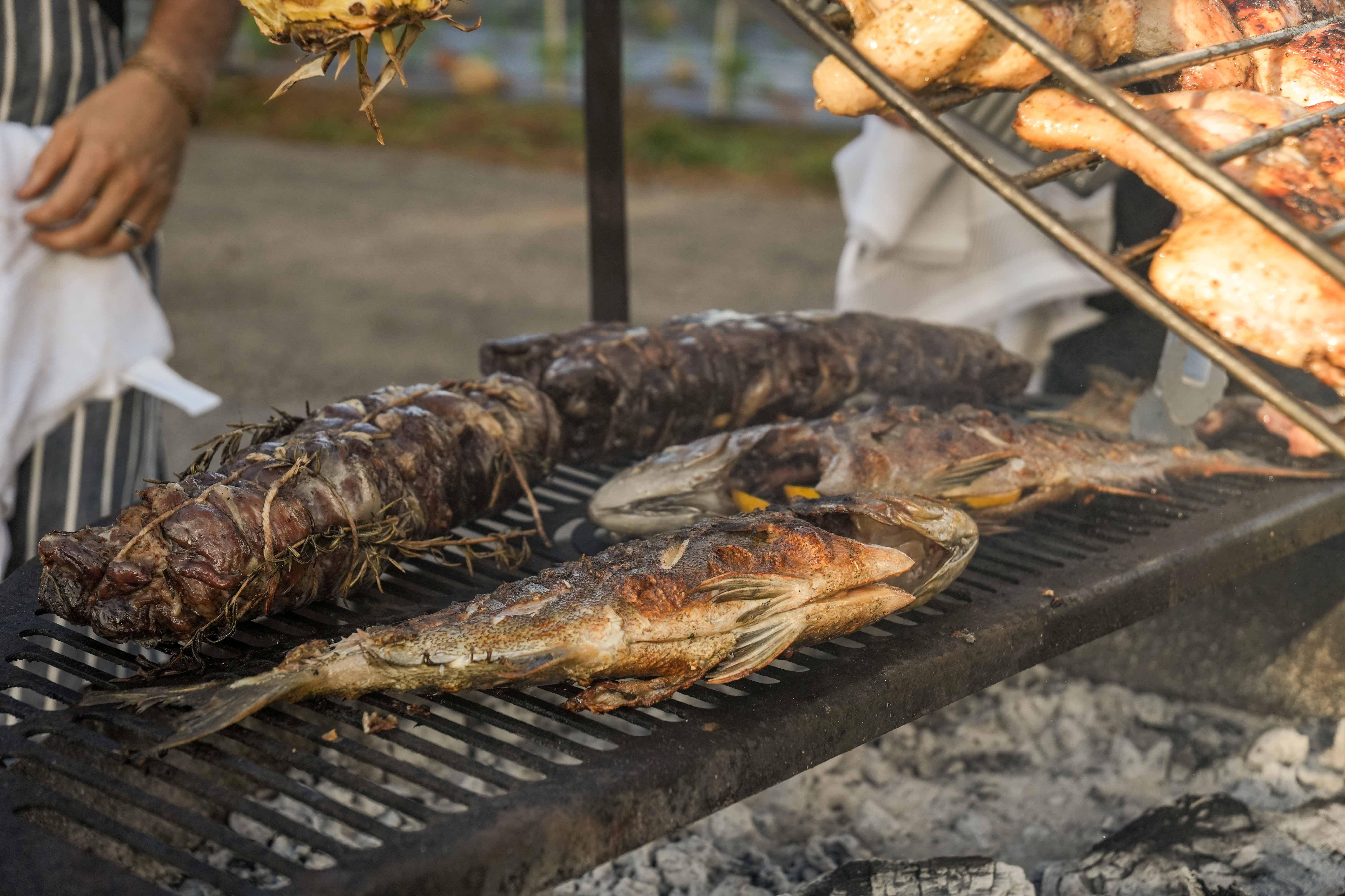 Whole fish grilling over open flame