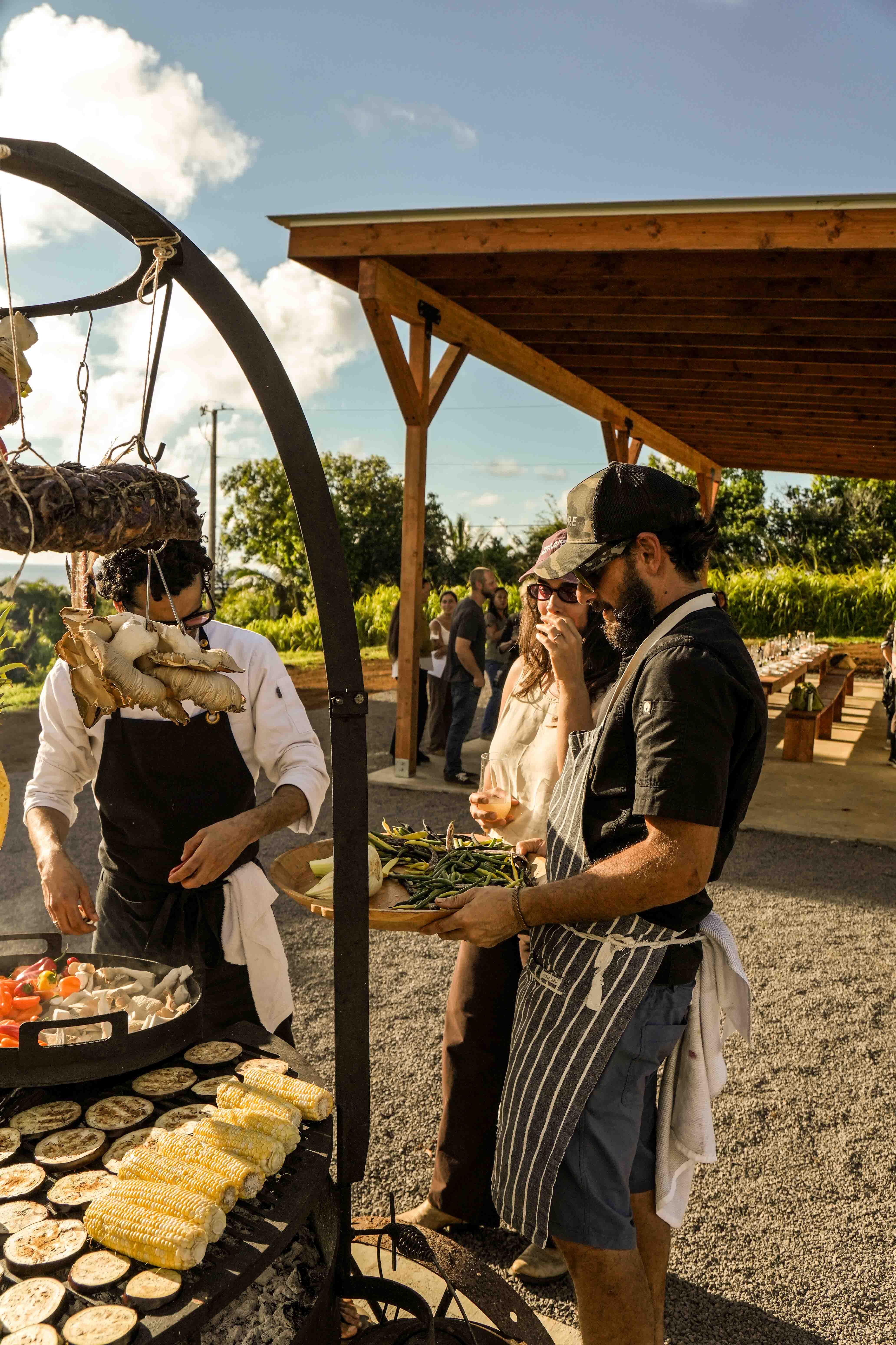 Chefs serving guests fresh from the grill