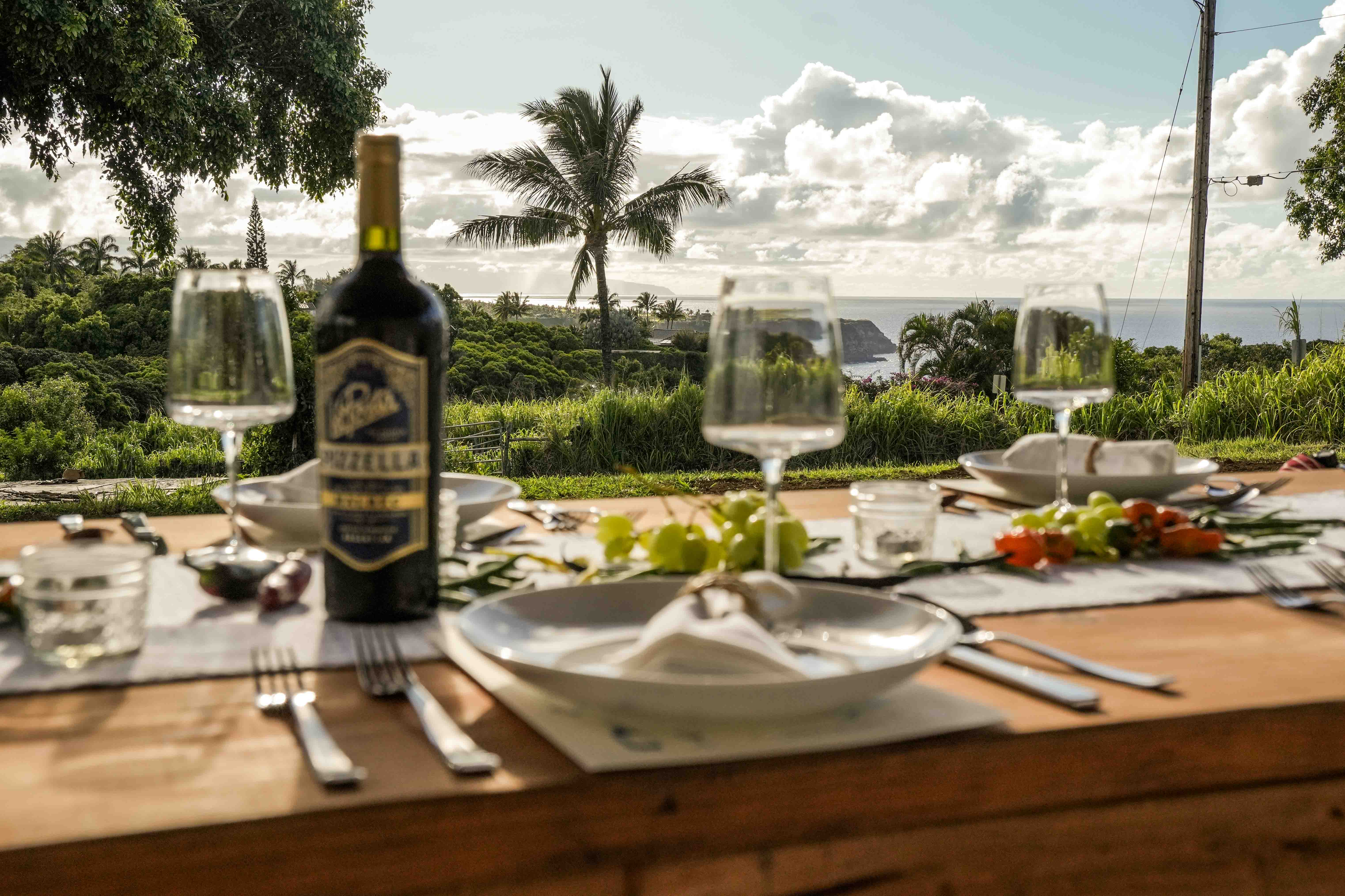 An evening farm-to-table dinner setting with the ocean beyond