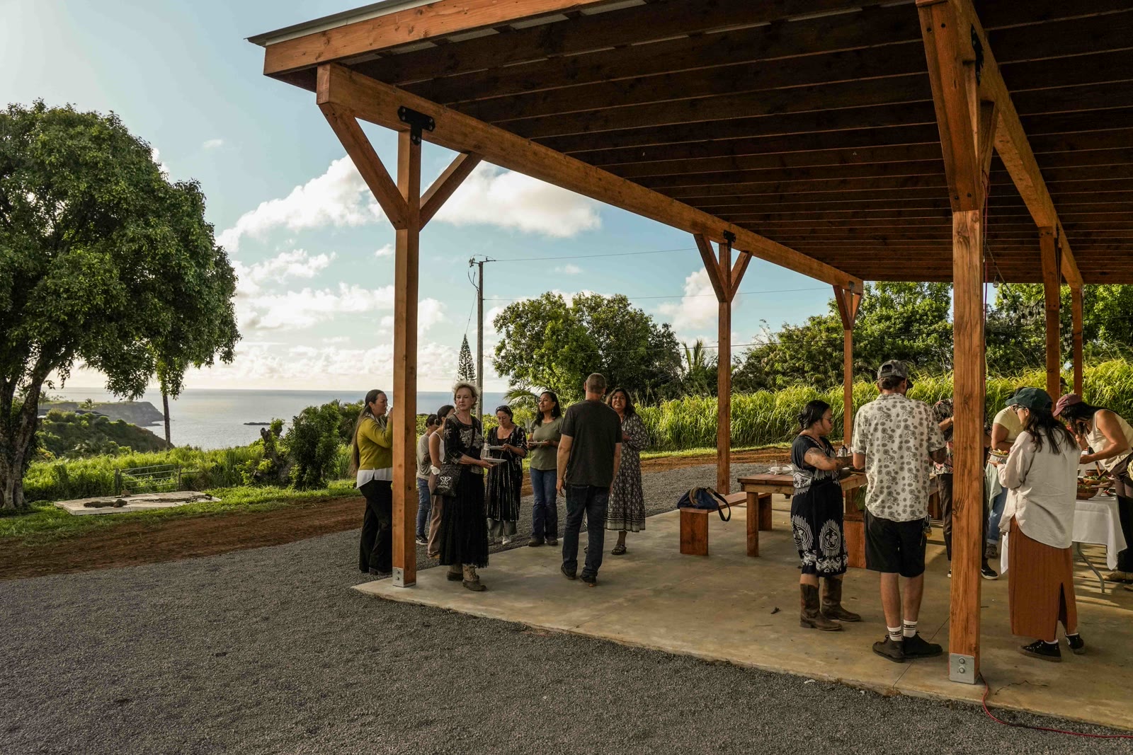 Guests gathered under the pavilion at golden hour