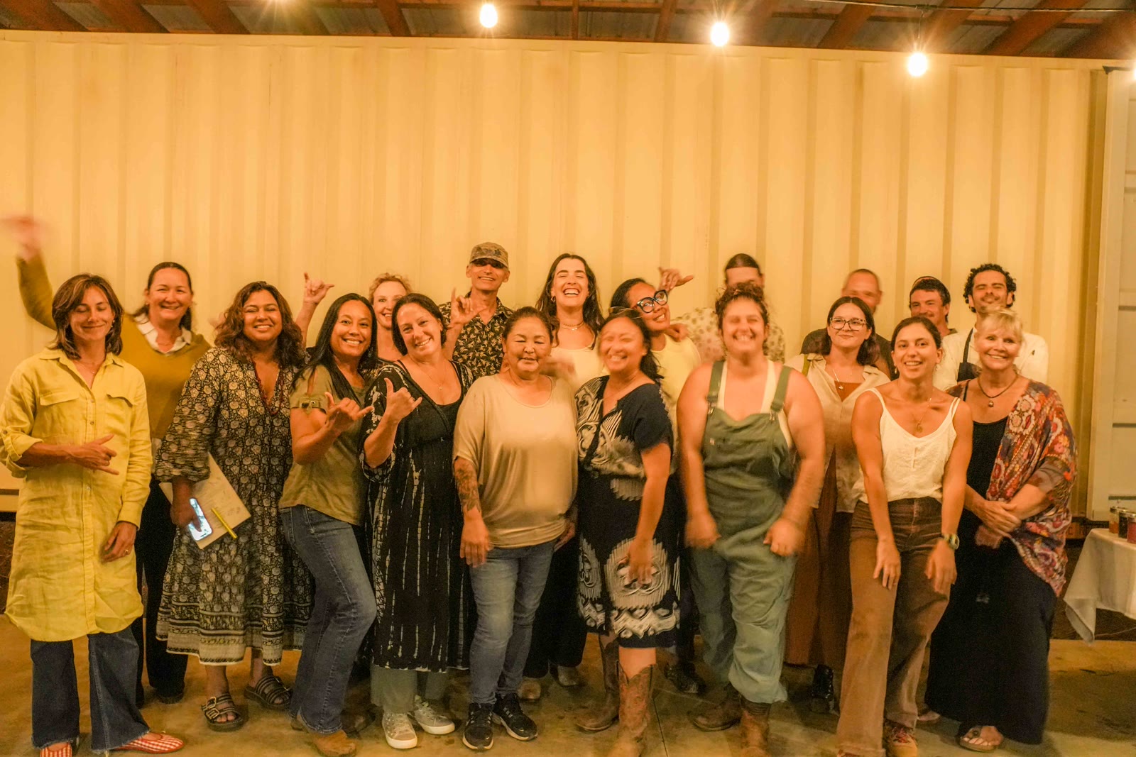 Guests and the team gathered for a group photo under the string lights